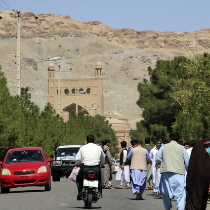 People gather near the site of an explosion at a mosque in Herat province, Afghanistan, on Friday. Photo: AP