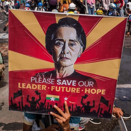 A protester holds a poster featuring Aung San Suu Kyi in a 2021 protest in Yangon, Myanmar. File photo: AFP