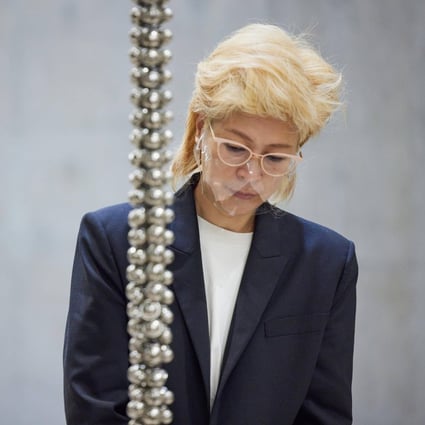 South Korean artist Haegue Yang at M+ with part of her work “Sonic Rescue Ropes” (2022). Photo: Dan Leung courtesy of M+ Hong Kong