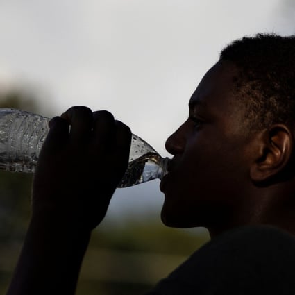 A volunteer drinks water during a break at a water distribution site as the city of Jackson is to go without reliable drinking water indefinitely after the water treatment plant pumps failed, leading to the emergency distribution of bottled water and tanker trucks for 180,000 people, in Jackson, Mississippi. Photo: Reuters
