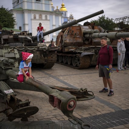 Children play on destroyed Russian military vehicles in central Kyiv, Ukraine on Saturday. Several children were killed and injured as a result of Russian attacks and the negligent handling of ammunition on Saturday. Photo: AP 