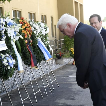 Israel’s President Isaac Herzog (R) looks on as German President Frank-Walter Steinmeier bows after laying a wreath during a ceremony marking the 50th anniversary of a fatal attack on the 1972 Munich Olympics. Photo: AFP