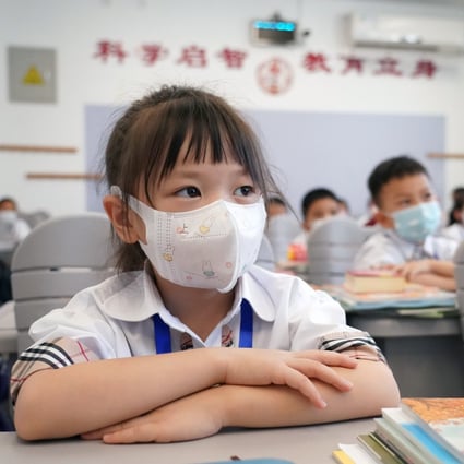 At Zhongguancun No 1 Primary School in Haidian district of Beijing, students attend class with masks. Photo: Xinhua