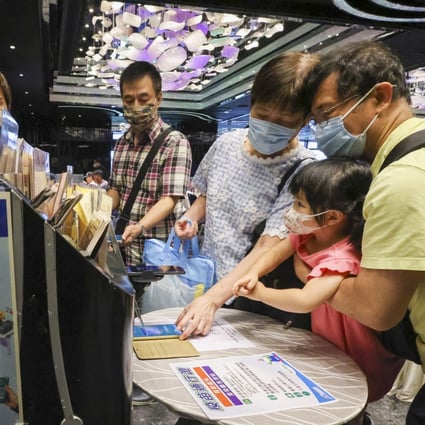 Patrons scanning the ‘Leave Home Safe’ app to enter a restaurant. Hong Kong will extend this measure to children as young as five. Photo: Dickson Lee