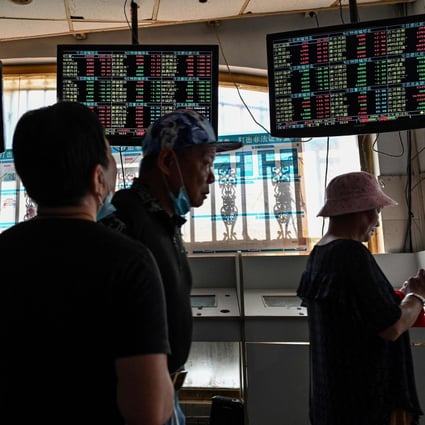 Investors monitor stock price movements inside a brokerage in Shanghai in September 2021. Photo: AFP