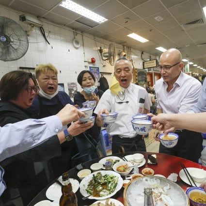 Robby Cheung (middle), co-owner of Tung Po Kitchen, toasts with customers on its second to last night of business. While rules were doubtless broken, the severity of the punishment n forcing it to shut highlights Hong Kong’s problem with blind bureaucracy. Photo: Dickson Lee