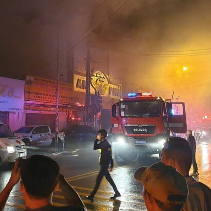 Firefighters at the scene of a deadly blaze that engulfed a karaoke bar in Thuan An, Vietnam’s Binh Duong province, on Tuesday night. Photo: Vietnam News Agency / AFP