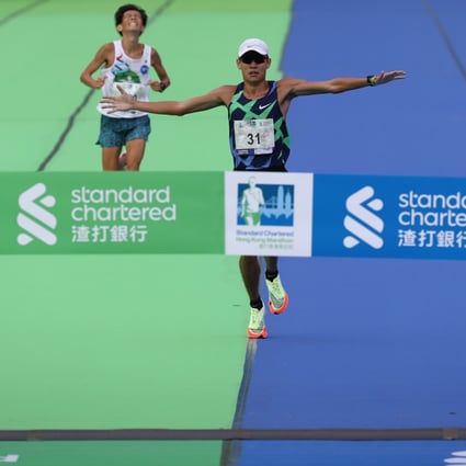 Men’s marathon champion Wong Kai-lok (front) and  Masashi Shirotake, in second, arrive at Standard Chartered Hong Kong Marathon 2021 finish line at Victoria Park, Causeway Bay. Photo: Nora Tam