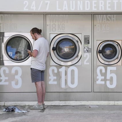 Amended prices are seen at a self-service laundry in Manchester, England, on September 7. According to reports, more than 1 million more people will be forced into poverty this winter, pushing UK deprivation levels to their highest for two decades even if the government freezes energy prices at current levels. Photo: AP