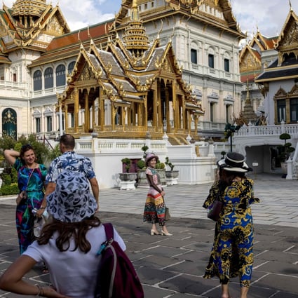 Tourists in the grounds of the Grand Palace in Bangkok on July 18, 2022. Photo: AFP