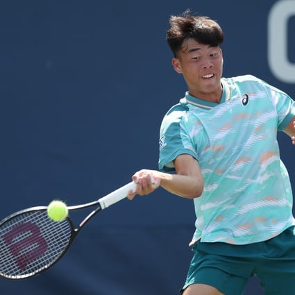 Coleman Wong hits a return against Gilles Arnaud Bailly during their junior boys’ semi-final. Photo: AFP