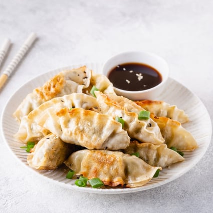 Fried gyoza dumplings with soy sauce. Dumplings feature in many cuisines, but with no agreed-upon history or definition, the only thing that ties them together is that they are made from common ingredients found on hand. Photo: Shutterstock