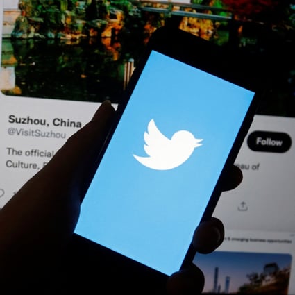 A Twitter logo is displayed on a mobile phone near a computer screen showing promoted tweets on China. Photo illustration: Reuters