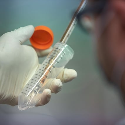 A technician conducts research on the Covid-19 virus at the University of Hong Kong on March 20, 2020. Photo: Bloomberg