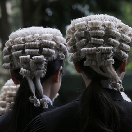 Barristers line up after an appointment ceremony for senior counsel outside the Court of Final Appeal in Hong Kong in June 2019. As a matter of course, the top court hears matters and writes its decisions in English. Photo: AP