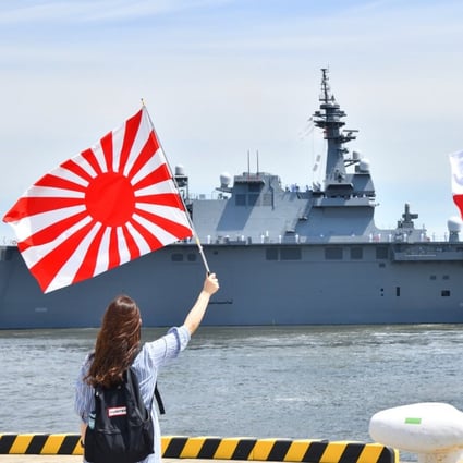 Onlookers wave flags, including the Rising Sun Flag of Japan’s Maritime Self-Defence Force, at the helicopter carrier Izumo, which is currently taking part in joint maritime drills with India’s navy in the Bay of Bengal. Photo: Twitter