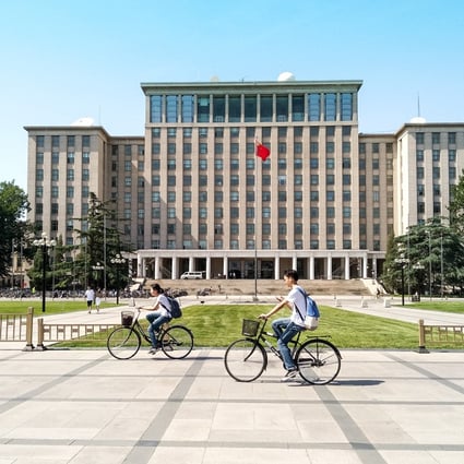Students cycling in front of the main entrance of the prestigious Tsinghua University in Beijing, China. Photo: 
Shutterstock 