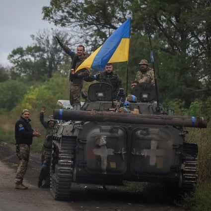Ukrainian service members on Wednesday stand on an infantry fighting vehicle near the town of Izium, recently liberated from Russian forces. Photo: Reuters