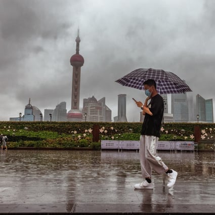 A man walks in Shanghai  as Typhoon Muifa loomed on Wednesday. Shanghai  grounded all flights from Pudong and Hongqiao airports, halted port operations, closed subway  stations and limited speed for ground trains. Ningbo, Taizhou, and Zhoushan city were ordered to suspend classes for the day.  Photo: EPA-EFE