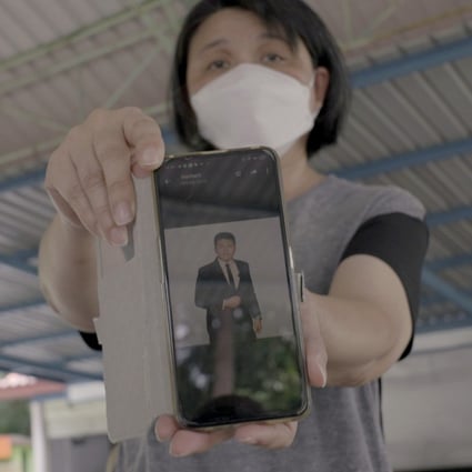 Malaysian Yang Fei Pin holds her phone showing a photograph of her late son Goi Zhen Feng. Photo: SCMP / Aidan Jones 