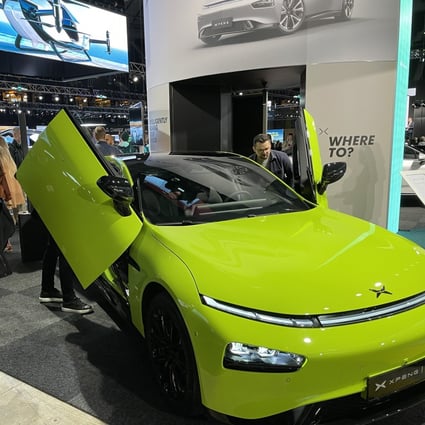 People inspect an electric vehicle shown by XPeng at the Swedish eCarExpo 2022 in Stockholm. Photo: Xinhua
