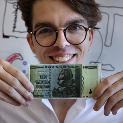 Eric Martinez, a graduate student in the brain and cognitive science department at the Massachusetts Institute of Technology, holding a Zimbabwean 10 trillion dollar bill on Sept 9. Martinez shares the Ig Nobel literature prize for research on what makes legal documents unnecessarily difficult to understand. Photo: AP