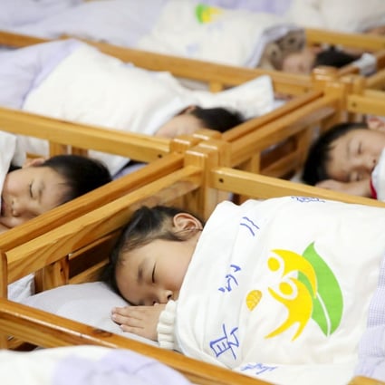Children learn about proper sleeping position at a kindergarten on World Sleep Day, March 19, 2021, in Ji’an, China’s Jiangxi Province. Photo: VCG via Getty Images