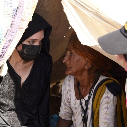 Angelina Jolie listens to a displaced woman in Dadu, Pakistan, on Tuesday following devastating rains and floods. Photo: Saima Javaid/IRC Handout via Reuters