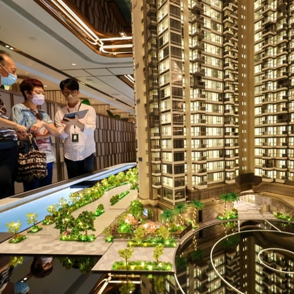 Potential buyers look at the model of a residential project in Hong Kong. Photo: Dickson Lee