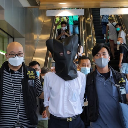 Police escort a suspect from a clinic in Chai Wan. Photo: Jelly Tse
