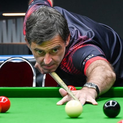 World No 1 and seven-time world champion Ronnie O’Sullivan demonstrates during a snooker lesson at his newly opened academy in Singapore. Photo: AFP