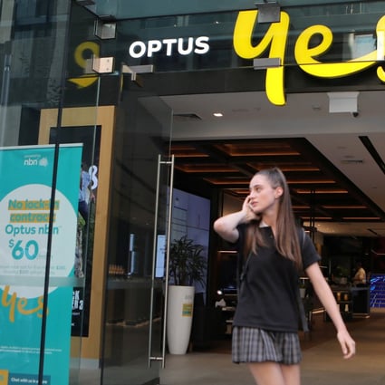 A woman uses her mobile phone as she walks past an Optus shop in Sydney, Australia, in 2018. File photo: Reuters