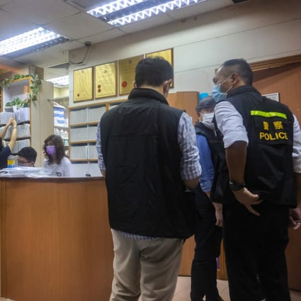Police officers investigate one of the three clinics involved in Thursday’s arrests.  Photo: Jelly Tse