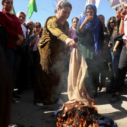 Women burn headscarves during a protest over the death of 22-year-old Kurdish woman Mahsa Amini in Iran, in the Kurdish-controlled city of Qamishli, Syria. Photo: Reuters