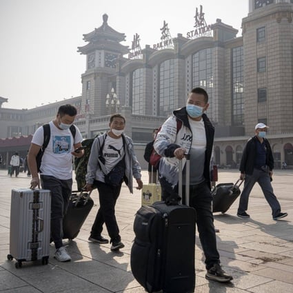 Travellers outside the Beijing Railway Station on Tuesday. Chinese have been urged to stay put during the “golden week” holiday. Photo: Bloomberg