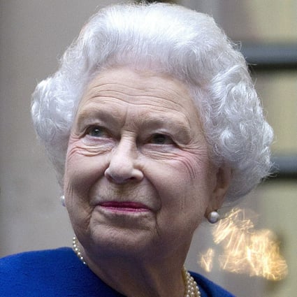 Britain’s Queen Elizabeth looks up and waves to members of staff of The Foreign and Commonwealth Office in London during an official visit in December 2012. Photo: AP