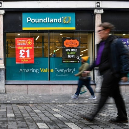 Pedestrians pass a pound store in Liverpool. Photo: Bloomberg