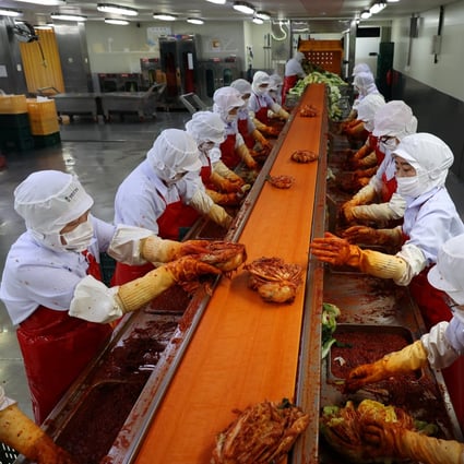 Employees work at Cheongone Organic kimchi factory in Cheongju, South Korea. Photo: Reuters