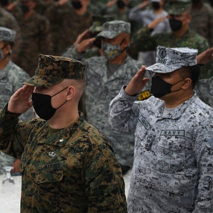 Philippine and US marines salute while their national anthems are played during the opening ceremony of “Kamandag” , a joint military exercise between US and Philippine marines on Monday. Photo: AFP