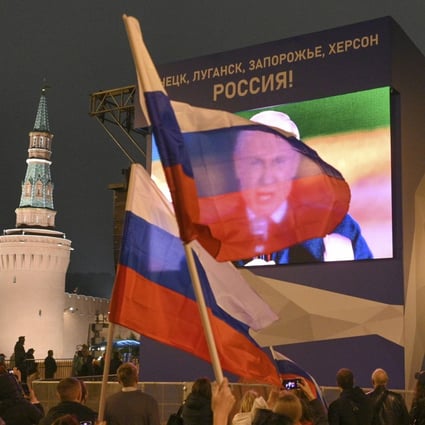 People in Moscow watch a large screen, as Russian President Vladimir Putin speaks during celebrations marking the incorporation of regions of Ukraine to join Russia. Photo: AP