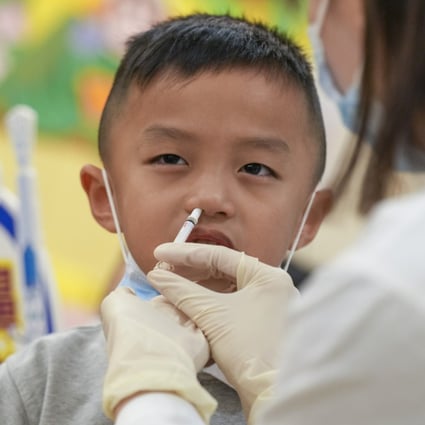 A child receives a nasal spray flu vaccine at Five District Business Welfare Association Cheung Chuk Shan Kindergarten on September 25. Photo: Sam Tsang