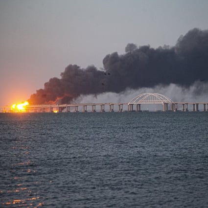 Flames and smoke rise from the Crimean Bridge connecting Russia and the Crimean peninsula over the Kerch Strait near Kerch, Crimea on Saturday. The bridge is a key supply artery for Moscow’s faltering war effort in southern Ukraine. Photo: AP