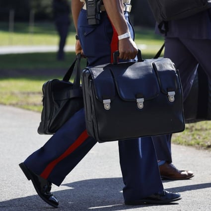 A military aide carries the ‘nuclear football’, as he follows US President Joe Biden, not pictured, onto Marine One. Photo: Bloomberg