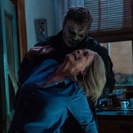 Jamie Lee Curtis (front) as Laurie Strode, and James Jude Courtney as The Shape, in a still from Halloween Ends.
