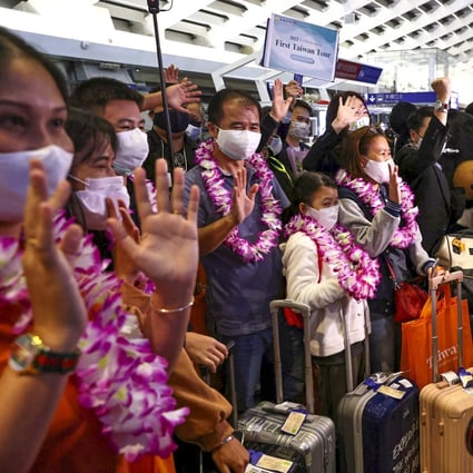 Flowers and mascots greet travellers from Thailand as they arrive on the first quarantine-free flight to Taiwan since the coronavirus pandemic began in 2020. Photo: Reuters 