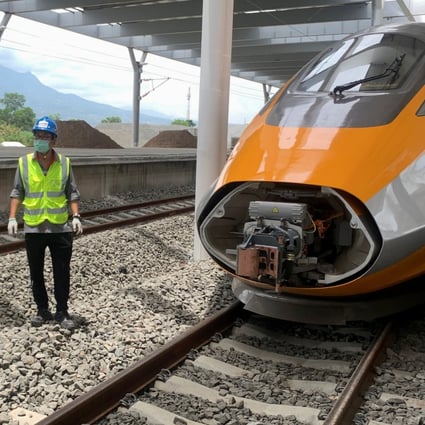 Workers stand beside a high-speed train in Bandung, Indonesia, on Thursday. Photo: Reuters
