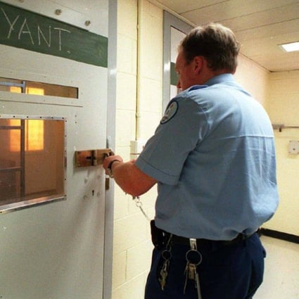 A prison officer in Australia locks up a cell. A UN team is due in the country to put pressure on it to do more to improve conditions for detainees and prevent human rights abuses. File photo: AFP