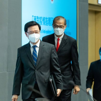 Hong Kong Chief Executive John Lee and health secretary Lo Chung-mau arrive at a news conference in Hong Kong on September 23 to announce the scrapping of hotel quarantine, the most substantial move in the city’s push to end its isolation and salvage its status as a global financial centre. Photo: Bloomberg