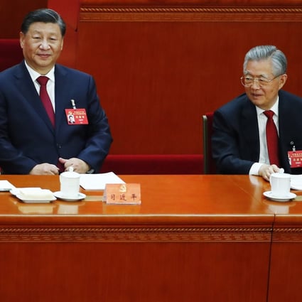 Former president Hu Jintao (right) took his seat beside his successor Xi Jinping on Sunday morning.  Photo: EPA-EFE