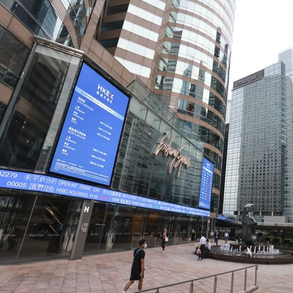 An electronic board displays the latest stock transactions outside Exchange Square in Central, Hong Kong. Photo: May Tse